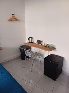 a desk with a chair in a room at B787 - City center room Papeete in Papeete
