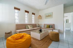 a living room with a couch and a table at Mont Choisy Lodge 7 Rooms, Large Pool, 2 Min Walk to Beach in Grand-Baie +66 photos