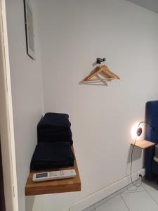 a room with a shelf with towels on a wall at DREAMLINER - City center room Papeete in Papeete