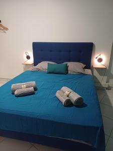a blue bed with towels on top of it at DREAMLINER - City center room Papeete in Papeete