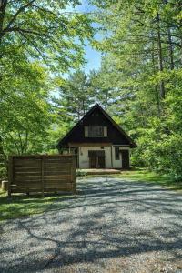 a barn with a fence in front of it at Cabin Dilusso in Hokuto