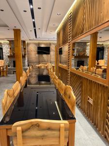 a row of chairs in a room with wooden walls at Moonlight House in Vusanje