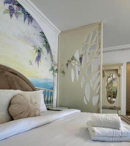 a bedroom with a large bed with a painting on the wall at Bridge Apartments in Timişoara