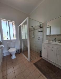 a bathroom with a toilet and a shower and a sink at Abbivale Farm Cottage in Harewood +20 photos