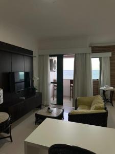 a living room with a couch and a television at Caesar Towers Hotel by Asas Tur in Recife