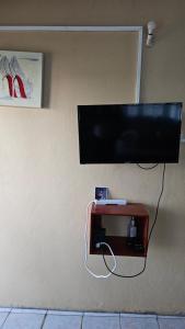 a flat screen tv hanging on a wall at Smithy's Apartment 2 in Ribishi