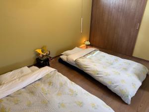 a bedroom with two beds in a room at Private house 海Kai in Nagato +39 photos