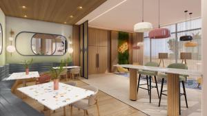 a dining room with tables and chairs and a mirror at Hampton By Hilton Jeddah Souq7 in Jeddah
