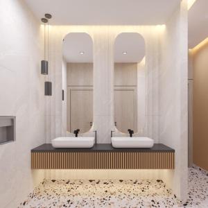two sinks in a bathroom with two mirrors at Hampton By Hilton Jeddah Souq7 in Jeddah +18 photos