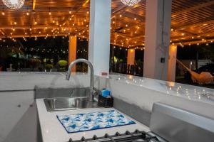 a kitchen counter with a sink and a stove at Brisas del Mar, Costa Azul - Private Pool in Acajutla +85 photos