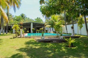 a house with a swimming pool and palm trees at Brisas del Mar, Costa Azul - Private Pool in Acajutla