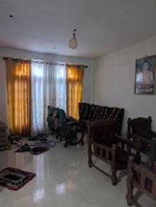 a living room with two chairs and a couch at Luxforge home in Bandarawela