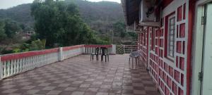 a balcony with a table and chairs on a building at Lucky Homes in Srīvardhan