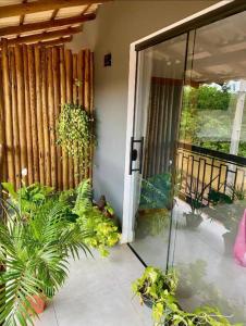 a sliding glass door to a house with plants at EcoStay Lençóis - apartamento in Lençóis