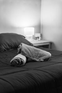 a towel is laying on a bed at Patagonia Sweet House in Puerto Natales
