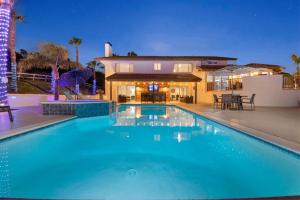 a large swimming pool in front of a house at Panorama Peak Luxury Retreat in Poway