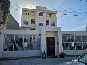 a building with a gate in front of it at Modern apartment by Playas Bullring in Tijuana