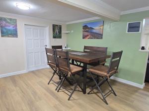 a dining room with a wooden table and chairs at Sunset Haven in Wallhouse