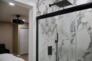 a bedroom with a shower with a glass door at VillaLuna Studio in Wellington