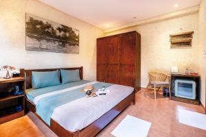 a bedroom with a large bed and a television at Về Homestay Ninh Bình in Ninh Binh