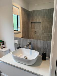 a bathroom with a white sink on a counter at Eastern Suburbs Gem in Forest Hill