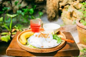 a plate of food and a drink on a table at Về Homestay Ninh Bình in Ninh Binh +48 photos