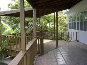 a porch of a house with a wooden deck at Tropical to go! Apt 1 in Fajardo +13 photos