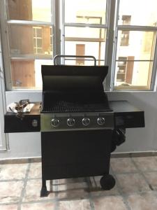 a black stove top oven in a room with windows at Tropical to go! Apt 1 in Fajardo