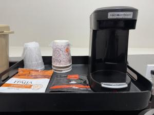 a coffeemaker sitting on top of a counter at The Overland Hotel Downtown Flagstaff NAU Conference Center in Flagstaff