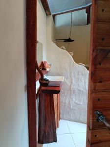 a bathroom with a sink and a mirror at Cabañas Ecológicas in Tela in Tela