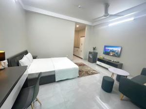 a bedroom with a bed and a table and chairs at CH home apartment in Hanoi +8 photos