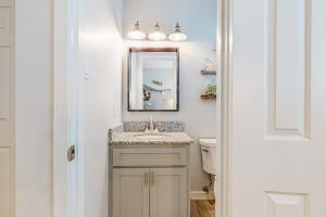 a bathroom with a sink and a mirror and a toilet at Leeward Cove A8 in Corpus Christi +18 photos