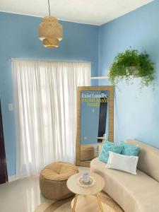 a living room with a couch and a table at 2BR w/mini dipping tub + 2 mins to beach in Mati