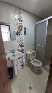 a bathroom with a toilet and a sink at Edificio K&C in Sogamoso +10 photos