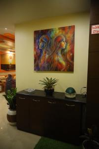a painting hanging on a wall in a room at Fussed Over Retreat in Siliguri