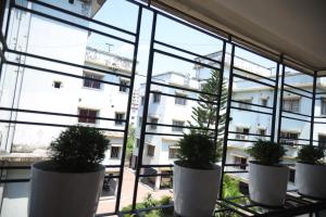 a window view of a building with potted plants at Fussed Over Retreat in Siliguri