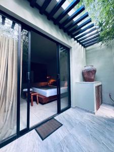 a room with sliding glass doors with a bed outside at Bernardino in Valladolid