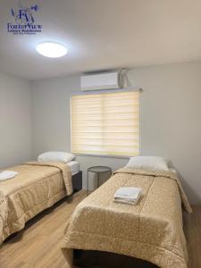 a room with two beds and a window with a heater at Forest View Leisure Residences in Olongapo +31 photos