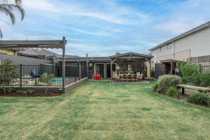 a house with a patio and a yard at Salty Breeze on Graeme in Dromana