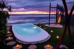 a swimming pool on the beach at sunset at Bubble 1 - Romantic Private Pool Love Dome Uluwatu in Uluwatu +11 photos