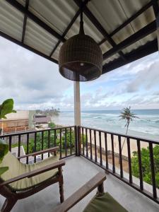 a balcony with a view of the ocean at Ahangama Surf Club in Ahangama