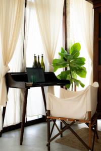 a desk with a laptop and a chair in front of a window at Ahangama Surf Club in Ahangama +62 photos
