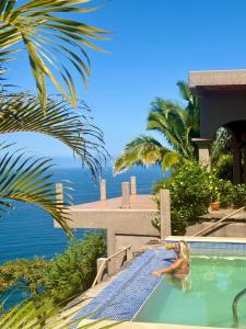 a woman in the swimming pool at a resort at The Sanctuary above Lo De Marcos in Lo de Marcos