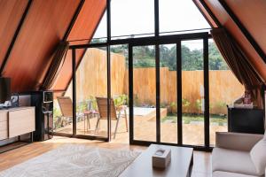 a living room with a large glass door with a patio at Sapphire Private Glamping in Bandung
