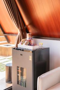 a small refrigerator with food on top of it at Sapphire Private Glamping in Bandung
