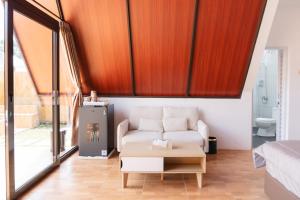 a living room with a couch and a table at Sapphire Private Glamping in Bandung