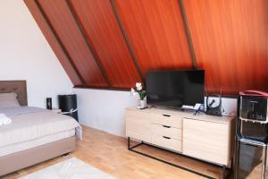 a bedroom with a bed and a television on a dresser at Sapphire Private Glamping in Bandung +12 photos