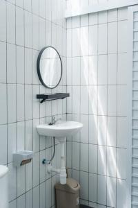a bathroom with a sink and a mirror and a toilet at Sapphire Private Glamping in Bandung