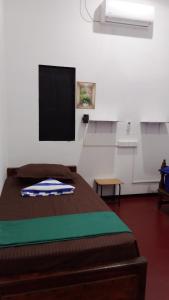 a room with a bed and a flat screen tv at Zeenath Villa - Arugambay in Arugam Bay
