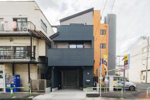 a building with a black facade on a city street at Tokyo stay 365 in Tokyo